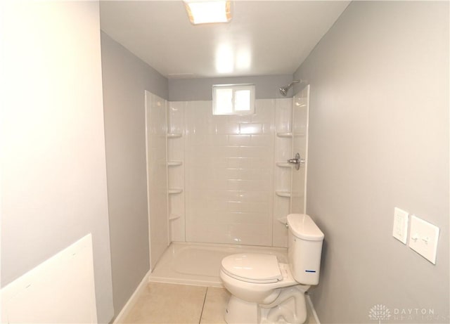 full bath with tile patterned flooring, baseboards, toilet, and walk in shower