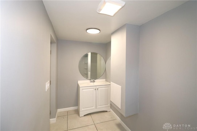 bathroom featuring tile patterned flooring, vanity, and baseboards