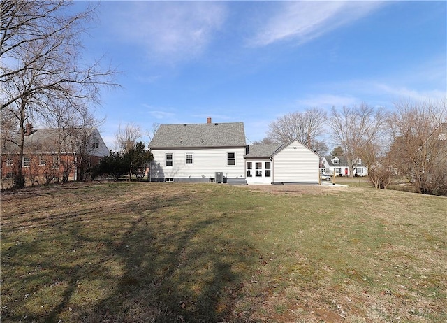 rear view of house featuring a patio area, cooling unit, and a yard