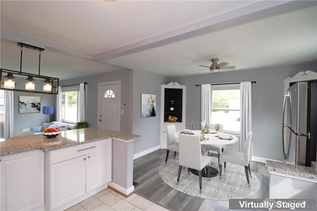 dining space with baseboards, a healthy amount of sunlight, light wood-style flooring, and a ceiling fan