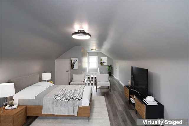 bedroom featuring wood finished floors and vaulted ceiling