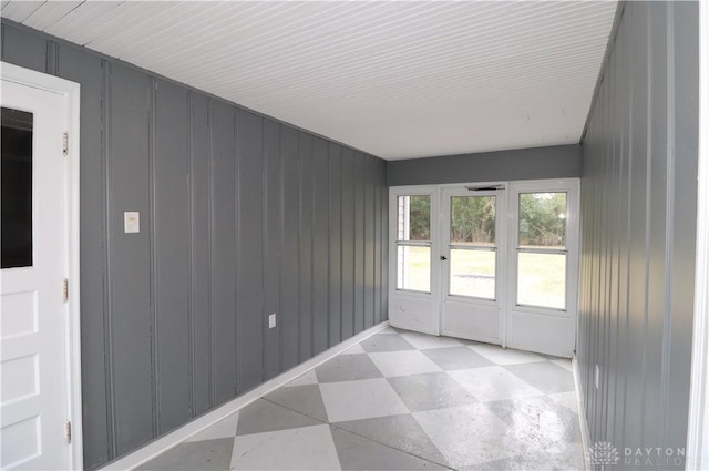 unfurnished sunroom featuring french doors