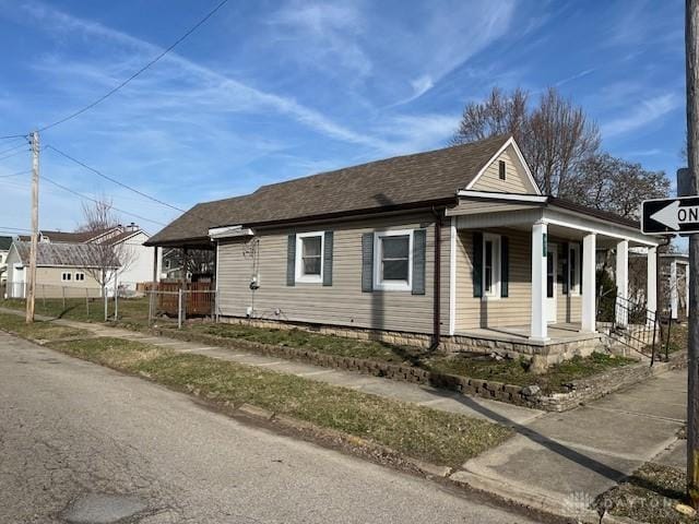 view of front of home with a porch and roof with shingles