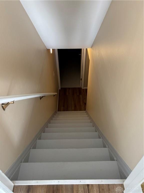 staircase featuring wood finished floors