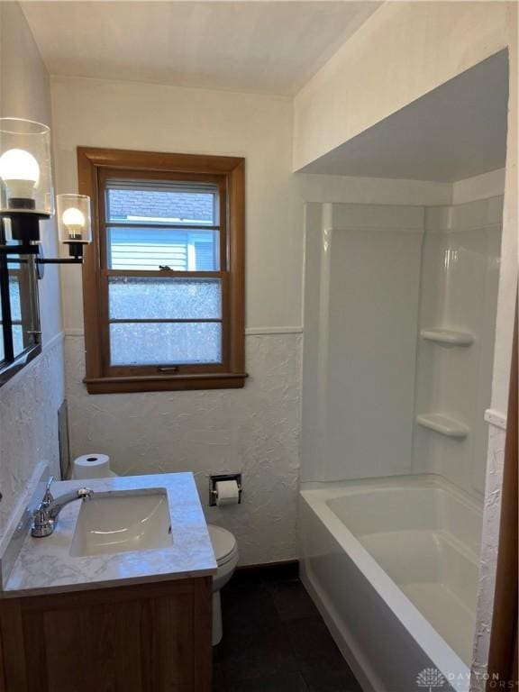 full bath featuring walk in shower, toilet, a bathing tub, a textured wall, and vanity