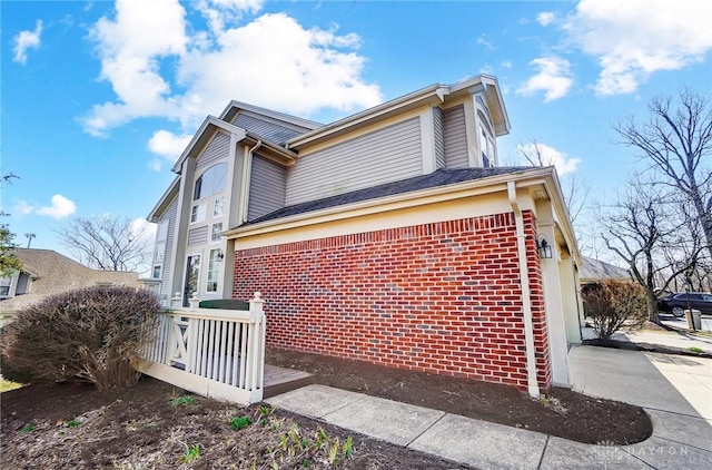 view of side of home with brick siding