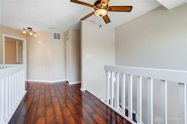 unfurnished room featuring visible vents, baseboards, a ceiling fan, and wood finished floors