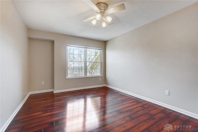 unfurnished room featuring baseboards, ceiling fan, and wood finished floors