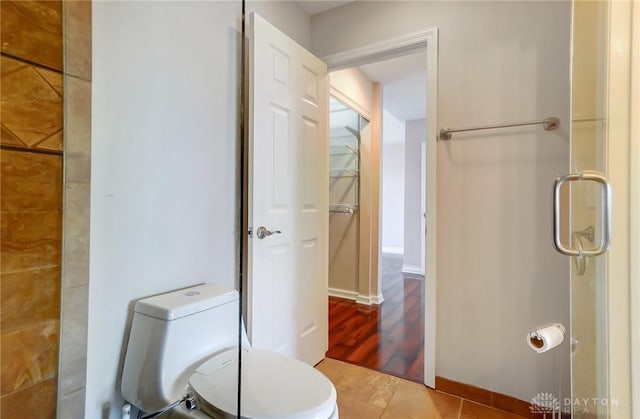 bathroom featuring toilet and tile patterned flooring