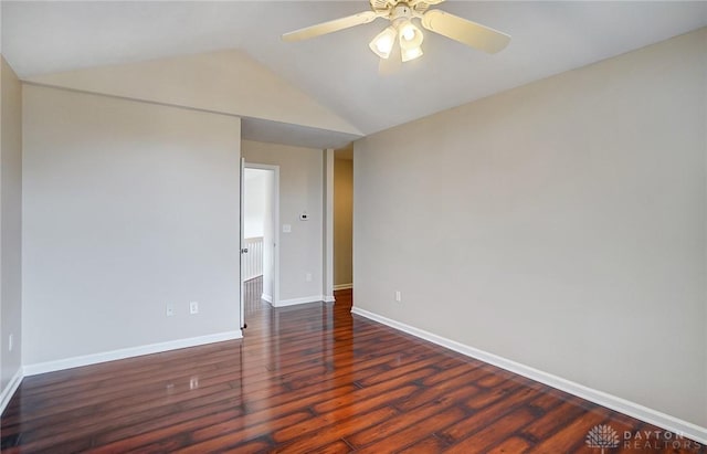 spare room with a ceiling fan, lofted ceiling, wood finished floors, and baseboards