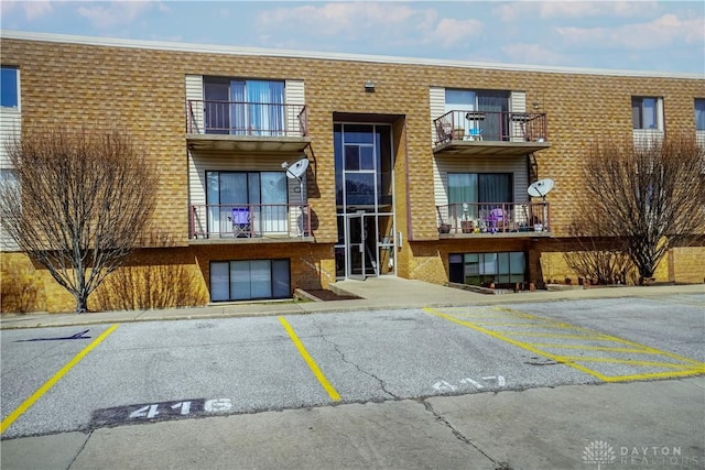 view of property featuring uncovered parking