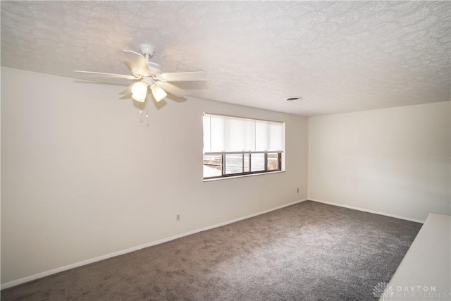 unfurnished room featuring baseboards, a textured ceiling, carpet, and a ceiling fan