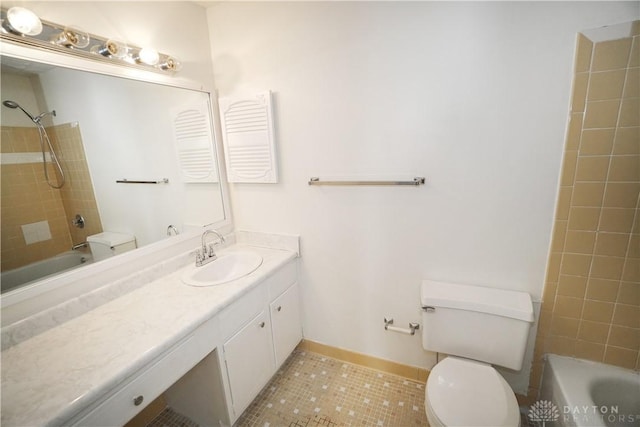 bathroom with tub / shower combination, baseboards, toilet, tile patterned floors, and vanity