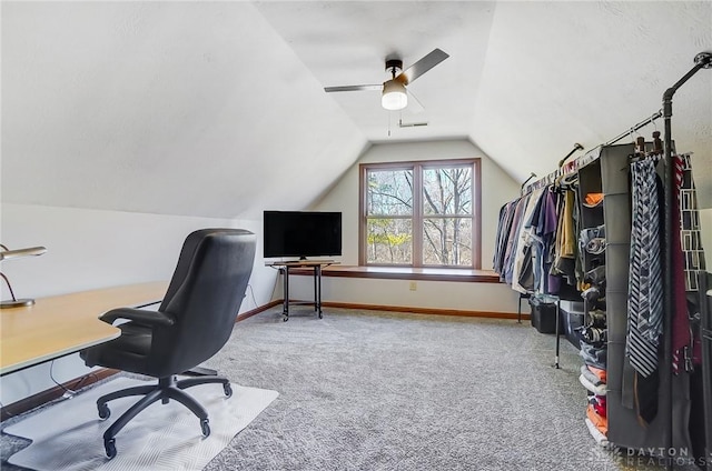 carpeted home office featuring baseboards, lofted ceiling, and a ceiling fan