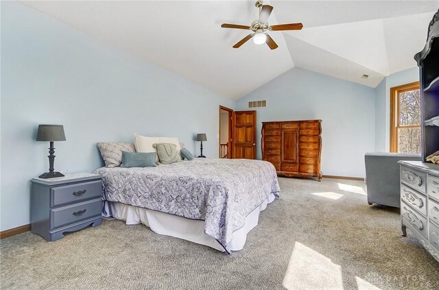 bedroom featuring visible vents, baseboards, light colored carpet, vaulted ceiling, and a ceiling fan