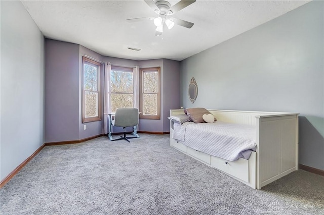 carpeted bedroom featuring visible vents, baseboards, and a ceiling fan