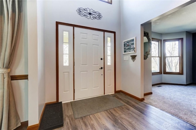 foyer with wood finished floors and baseboards