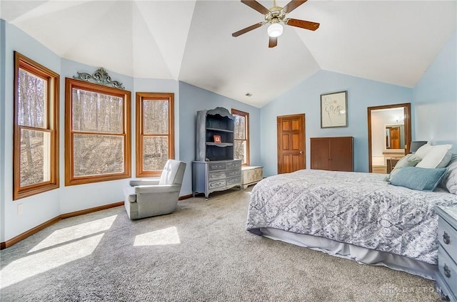 carpeted bedroom with baseboards, lofted ceiling, connected bathroom, and a ceiling fan