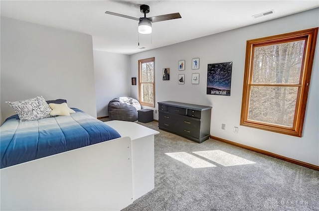 bedroom with ceiling fan, baseboards, visible vents, and light carpet