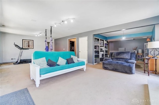 living area featuring carpet and visible vents