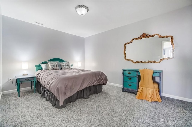 carpeted bedroom with visible vents and baseboards