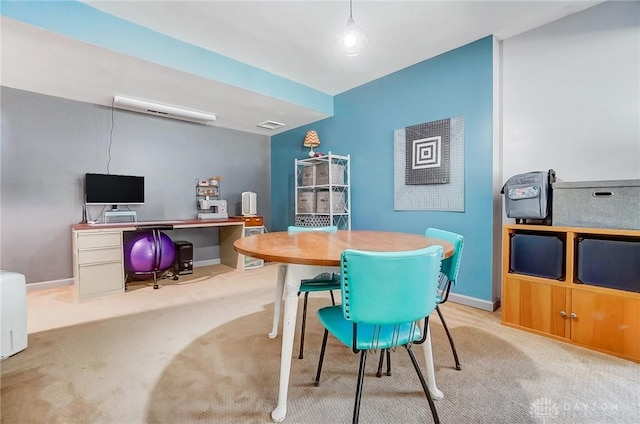 carpeted dining area featuring visible vents and baseboards