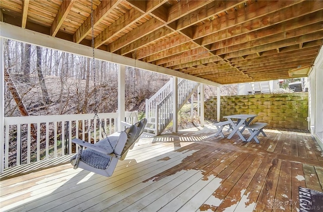 deck featuring stairs and outdoor dining area