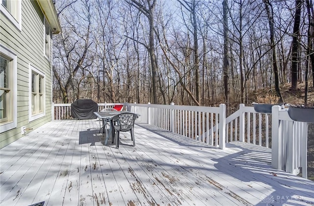 deck with outdoor dining area