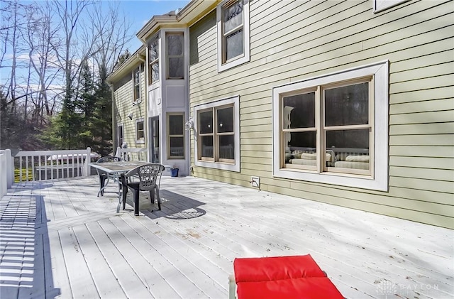 wooden terrace with outdoor dining space