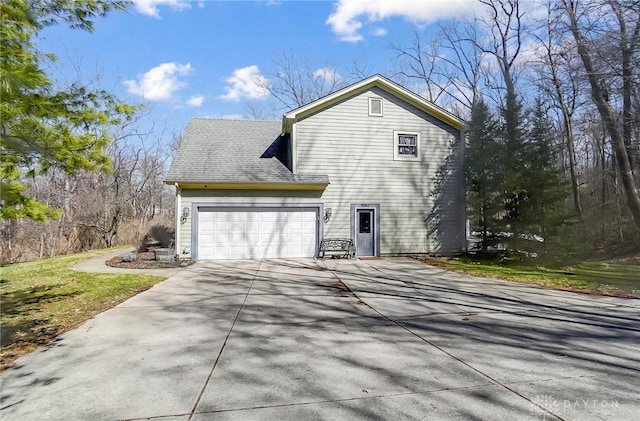 view of home's exterior with concrete driveway and an attached garage