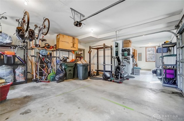 garage with electric panel and a garage door opener