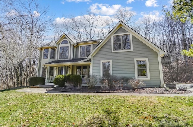 view of front of property with a porch and a front yard