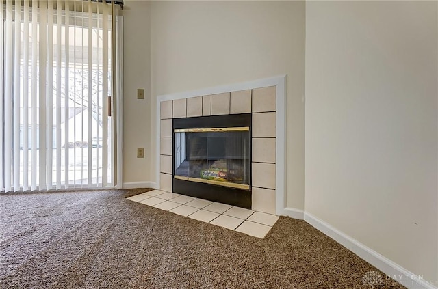 unfurnished living room with a wealth of natural light, baseboards, and carpet floors