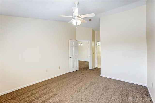 unfurnished bedroom featuring ceiling fan, baseboards, carpet, and vaulted ceiling