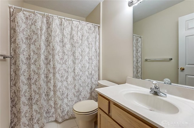 full bathroom with tile patterned floors, toilet, and vanity