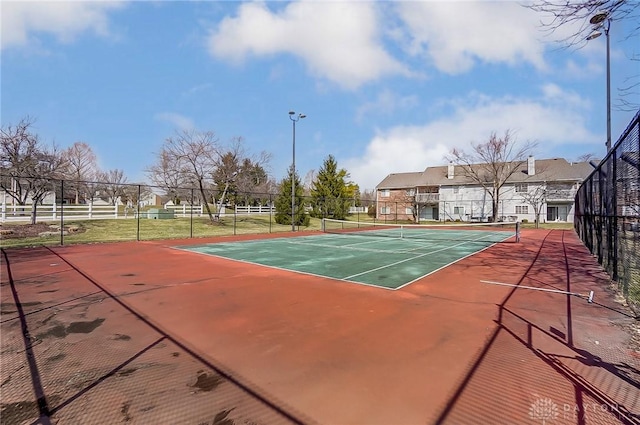 view of tennis court with fence