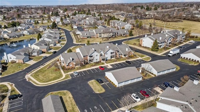 drone / aerial view with a residential view and a water view