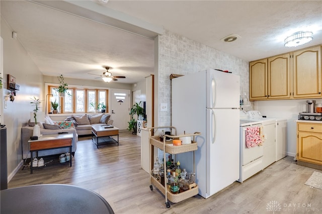 kitchen with light brown cabinets, ceiling fan, light wood-style flooring, freestanding refrigerator, and independent washer and dryer