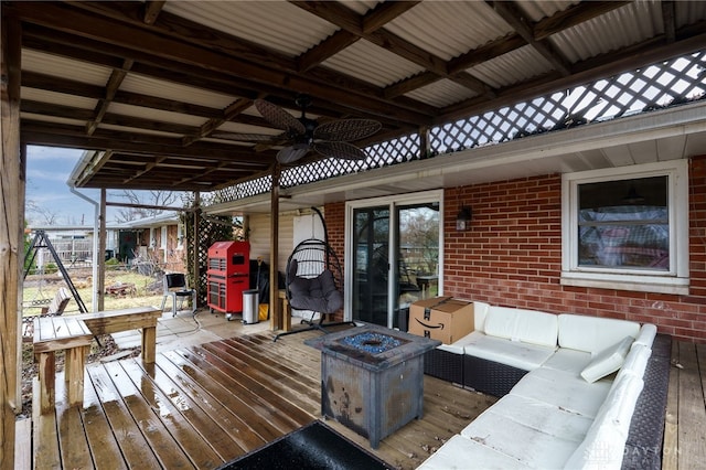 deck with outdoor lounge area and a ceiling fan