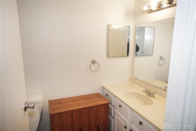 bathroom with toilet and vanity