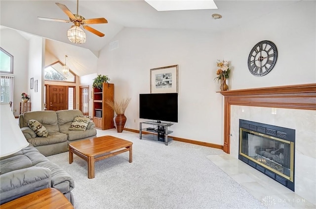 living room with visible vents, baseboards, carpet flooring, a skylight, and a ceiling fan