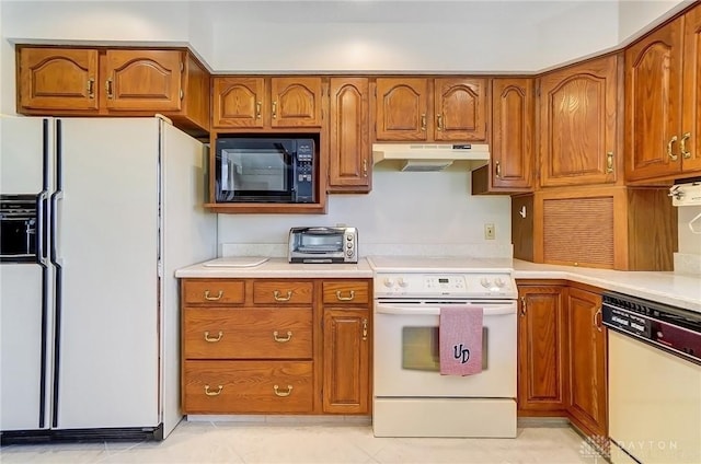 kitchen with under cabinet range hood, white appliances, and brown cabinetry