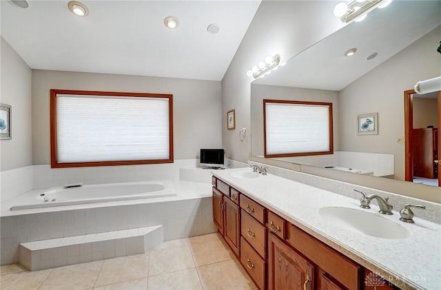 full bathroom featuring a bath, vaulted ceiling, and a sink