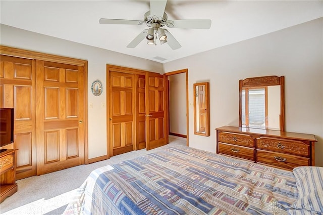 bedroom featuring visible vents, a ceiling fan, baseboards, and carpet floors