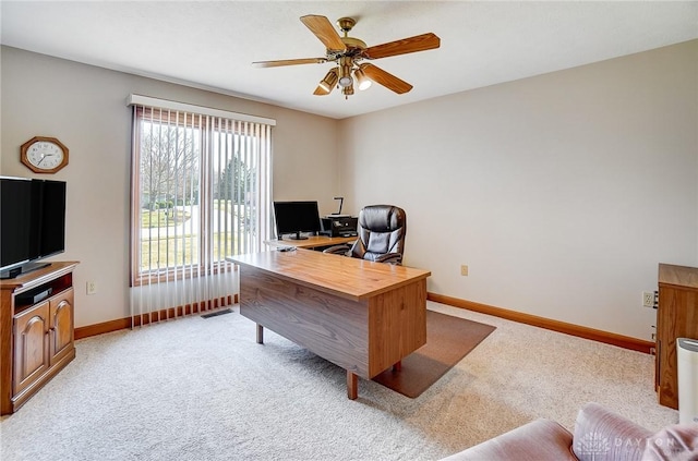 office space with baseboards, light carpet, visible vents, and a ceiling fan