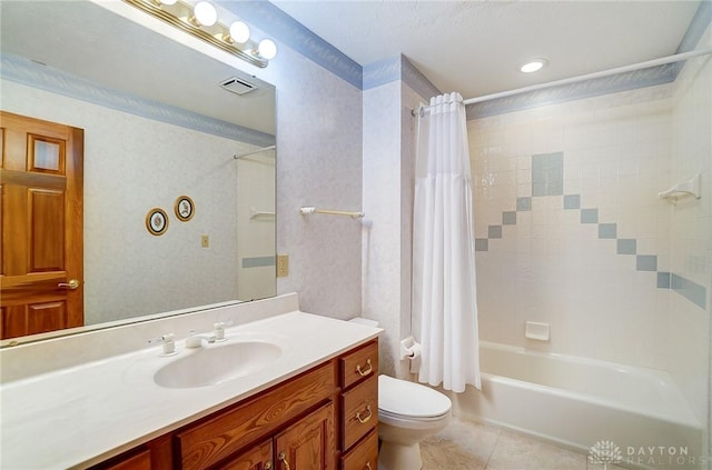 bathroom featuring tile patterned flooring, visible vents, toilet, shower / bath combo with shower curtain, and vanity