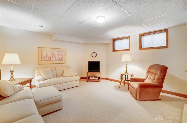 carpeted living room featuring visible vents, baseboards, and a paneled ceiling