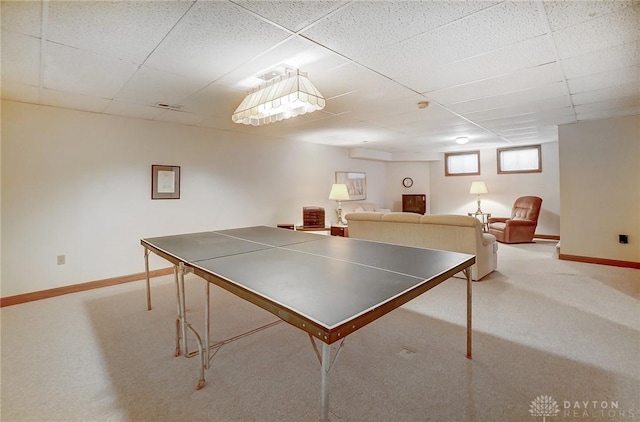 rec room with carpet flooring, baseboards, and a drop ceiling