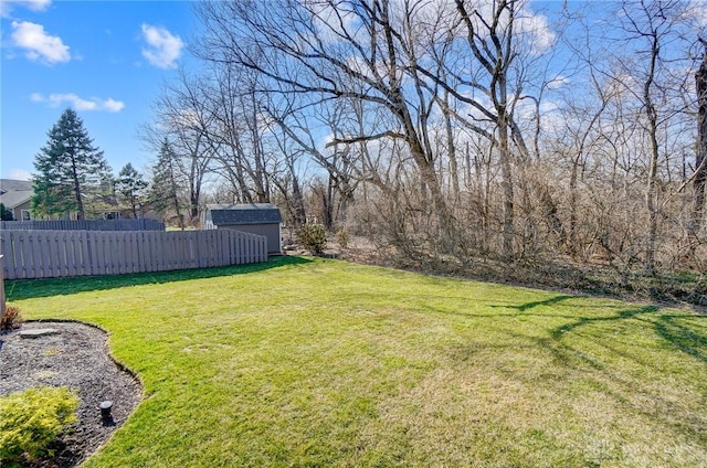 view of yard with a storage shed, an outdoor structure, and fence