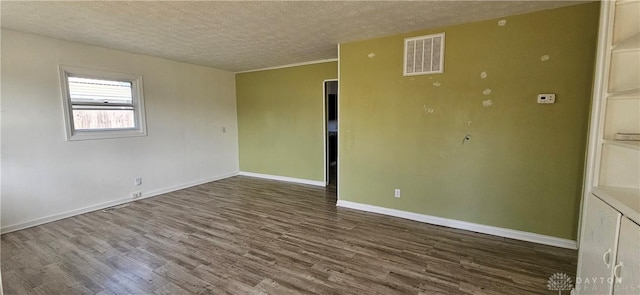 unfurnished room featuring visible vents, baseboards, a textured ceiling, and wood finished floors